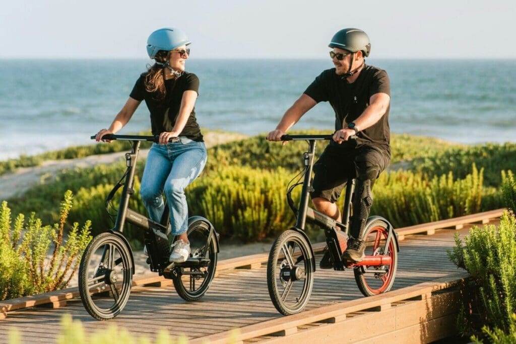 Couple Riding eBikes on Beach Boardwalk - eBike Beach Adventure
