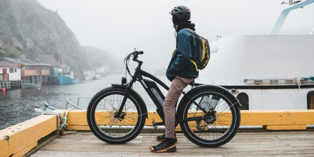 Man Riding eBike Enjoying Scenic View from Wooden Dock - Scenic eBike Adventure