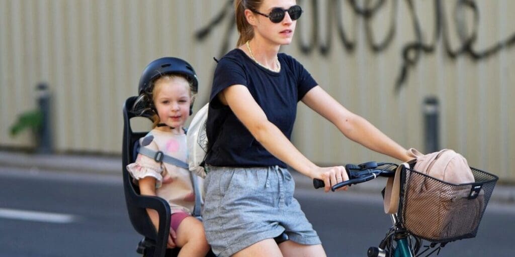 Mother and Child Riding e-Bike to Commute in City